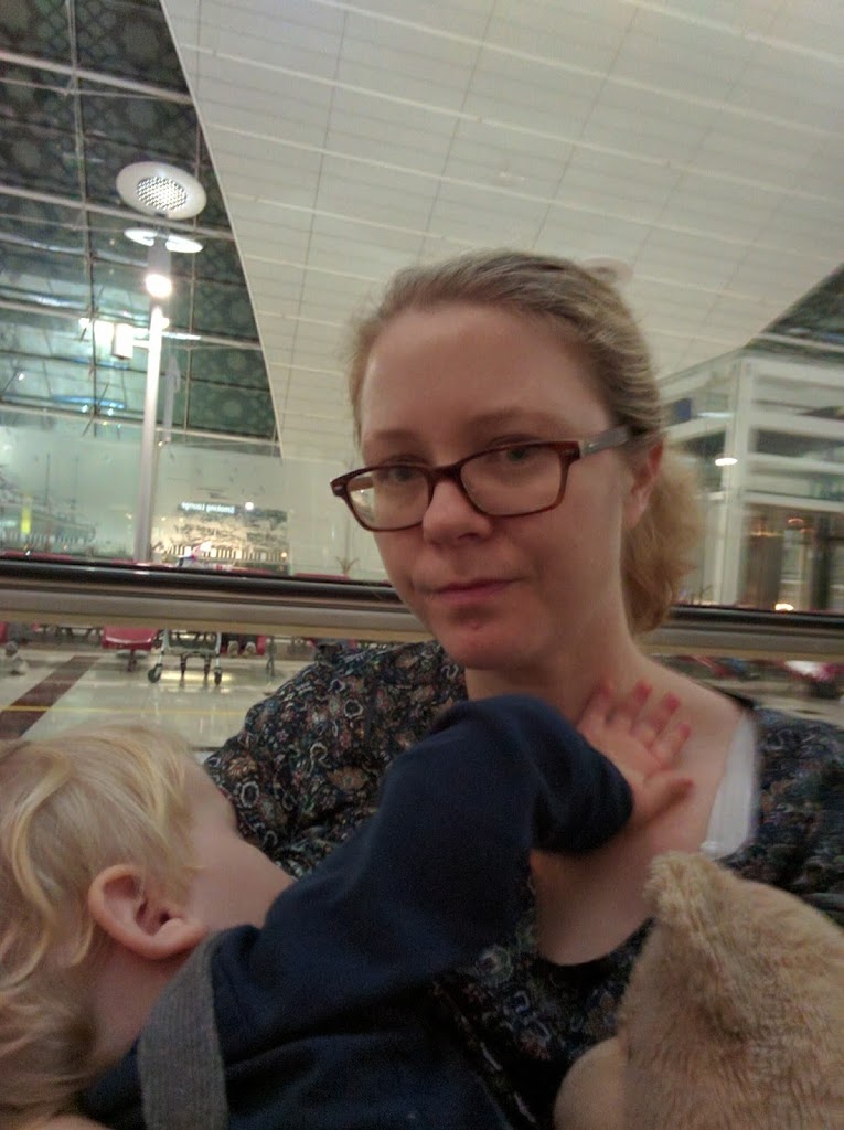 Mom on the airport breastfeeding her boy