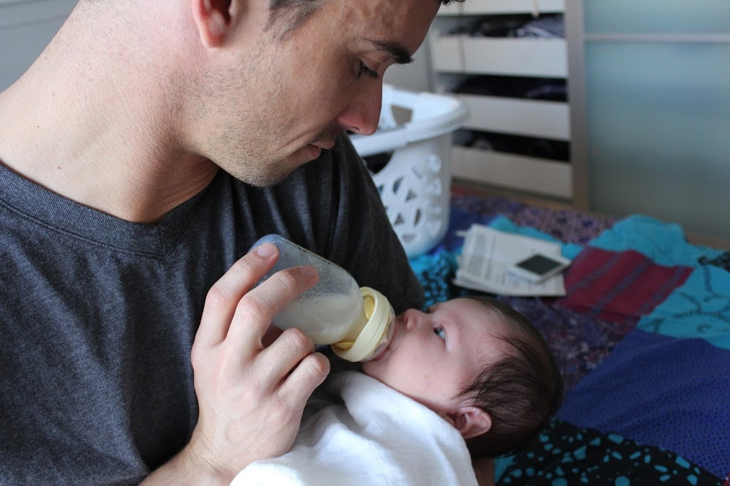 Dad feeding his baby